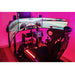 This is the Trak Racer TR160 Full Racing Simulator Setup - SPEC 4 closeup on the upper part of the sample build in a pink-red lit room with a sample racing game on the monitor.