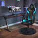 Blue GX2 Gaming Chair in a simple realistic gaming room setting with a few peripherals on top.