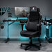 Black Warzone Gaming Chair in a realistic blue-backlit gaming room.