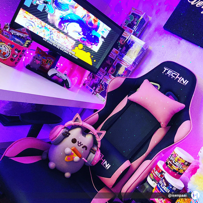 This is an image of the TS-4300 Ergonomic High Back Racer Style PC Gaming Chair in a colorful gaming room in front of a gaming computer set-up.