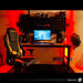 The TS-84 Ergonomic High Back Racer Style PC Gaming Chair in front of a heavily-orange-themed PC Gaming Set-up.
